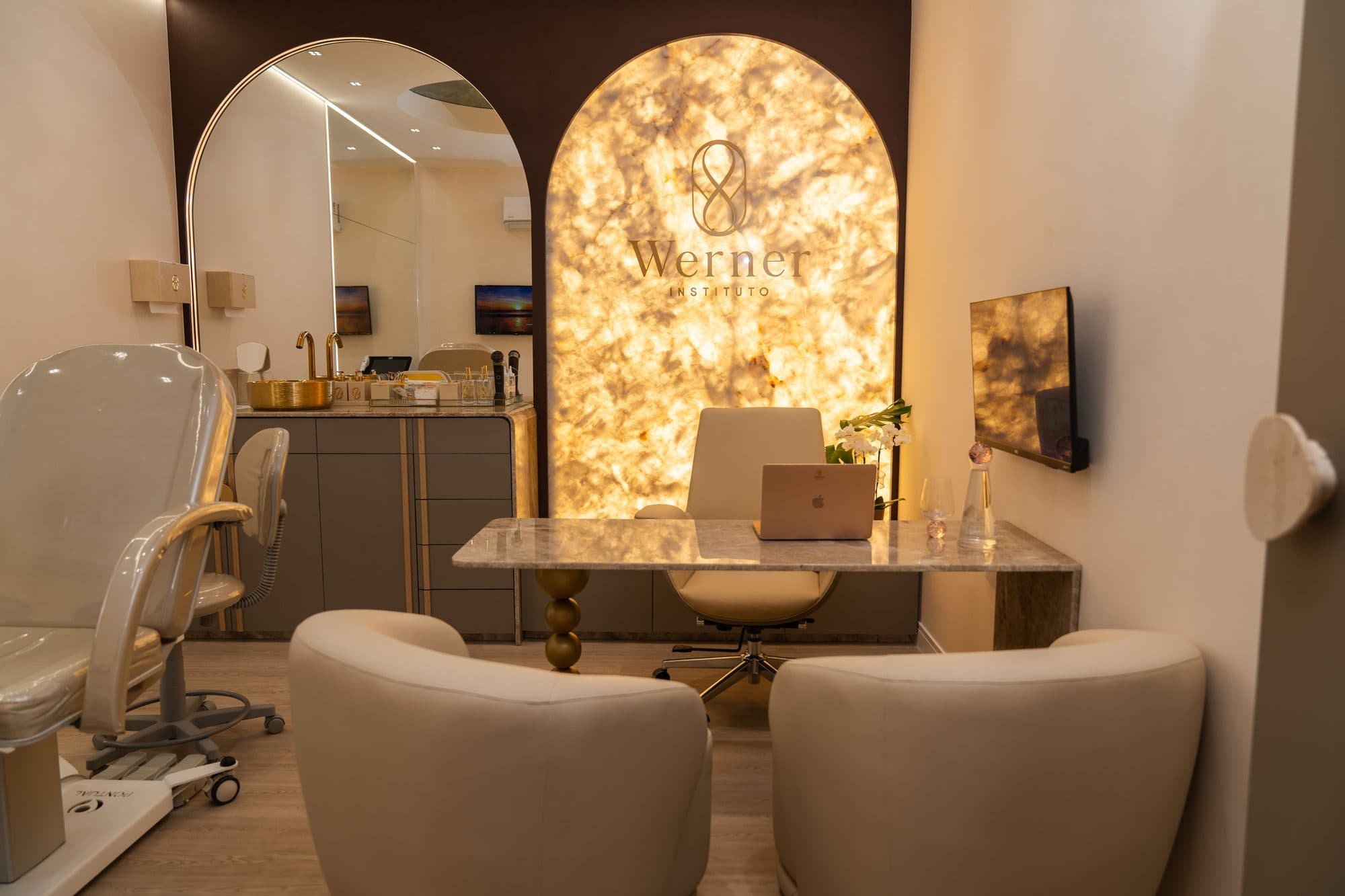Consultório com painel de ônix retroiluminado atrás da mesa