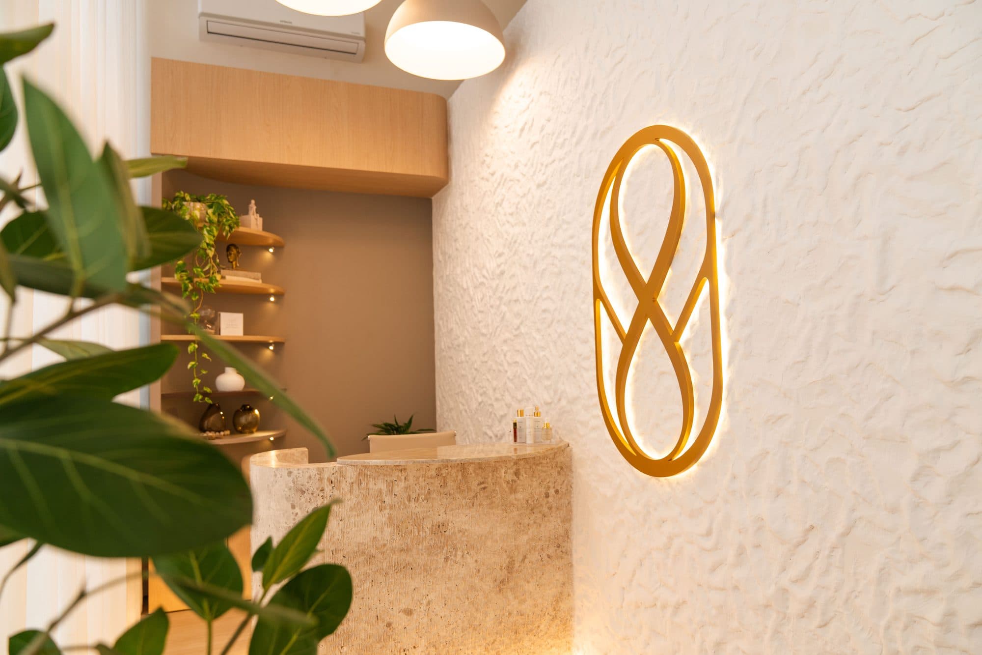 Recepção do Werner Instituto, com o monograma retroiluminado sobre a parede texturizada